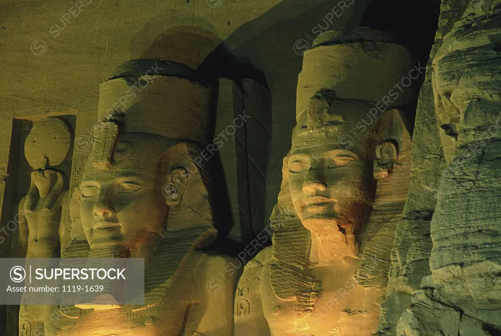 Close-up of statues lit up at night, Great Temple of Ramses II, Abu Simbel, Egypt