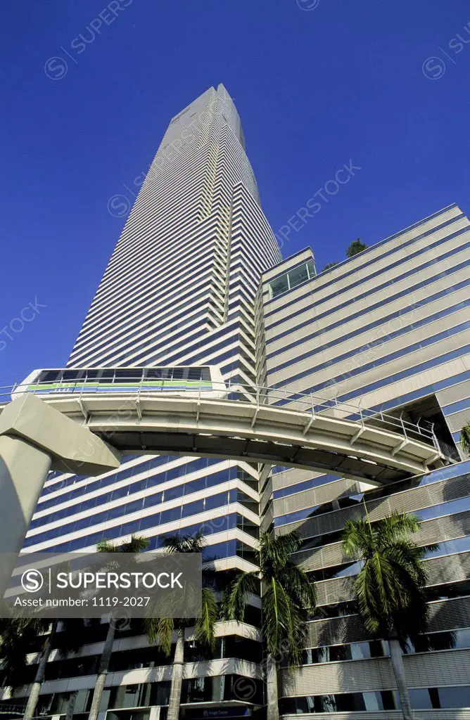 Low angle view of a commercial building and a metro train, Miami, Florida, USA