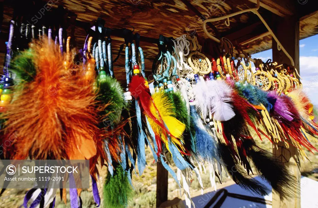 Close-up of craft products hanging in a market stall