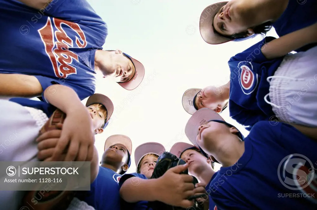 Low angle view of a group of boys on a baseball team in a huddle