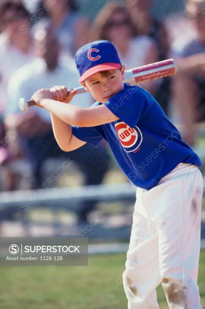 Boy swinging a baseball bat on a field