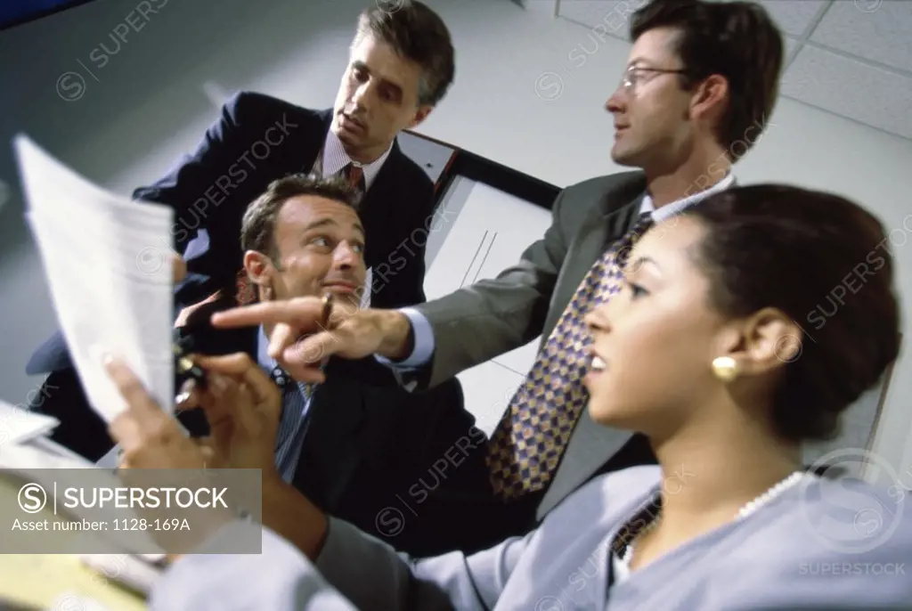Businesswoman with three businessmen in an office