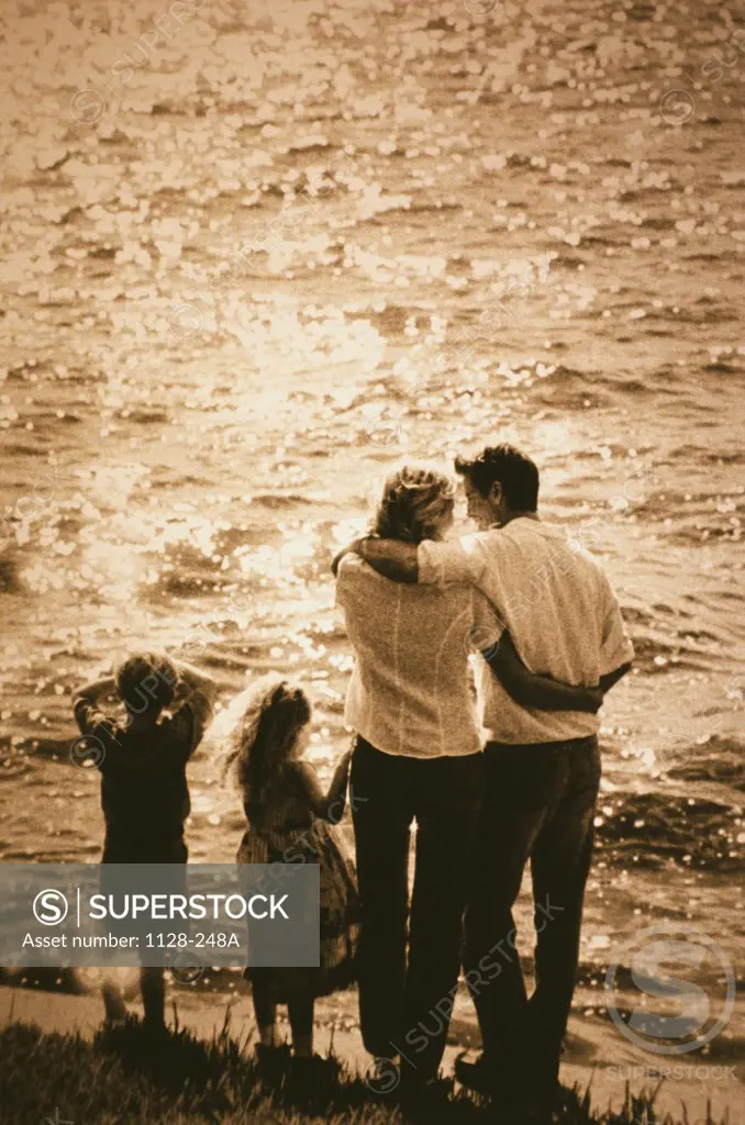 Rear view of a family standing at the beach