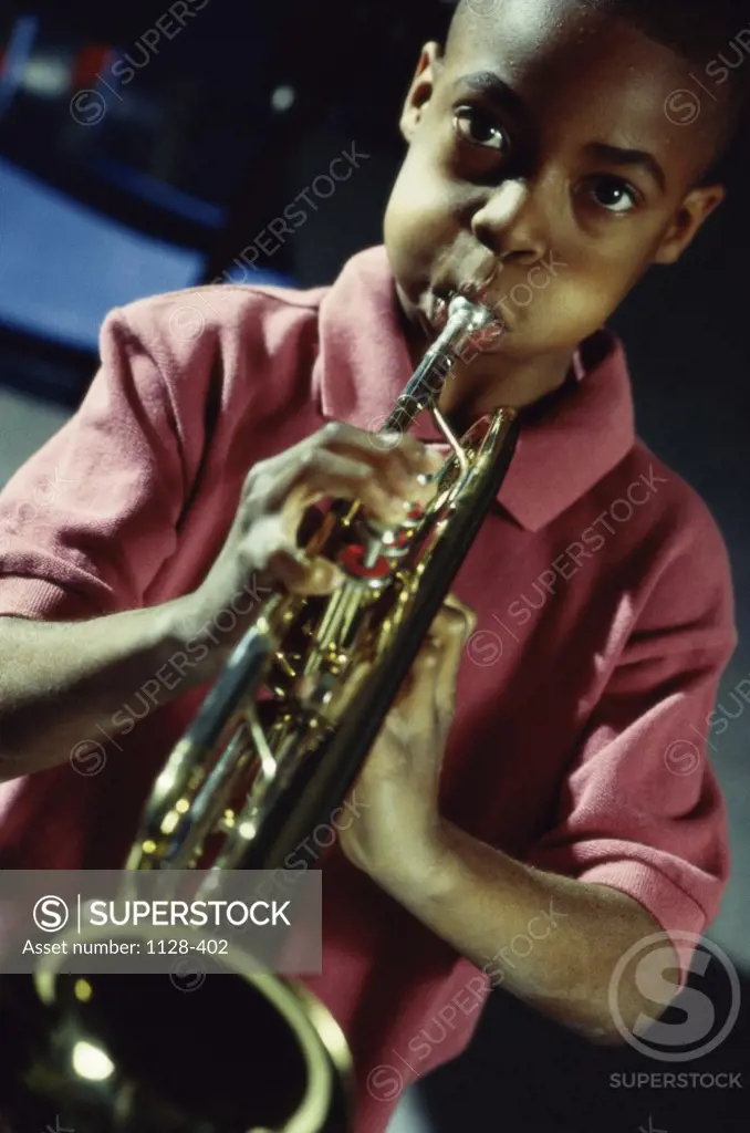 Portrait of a boy playing a trumpet