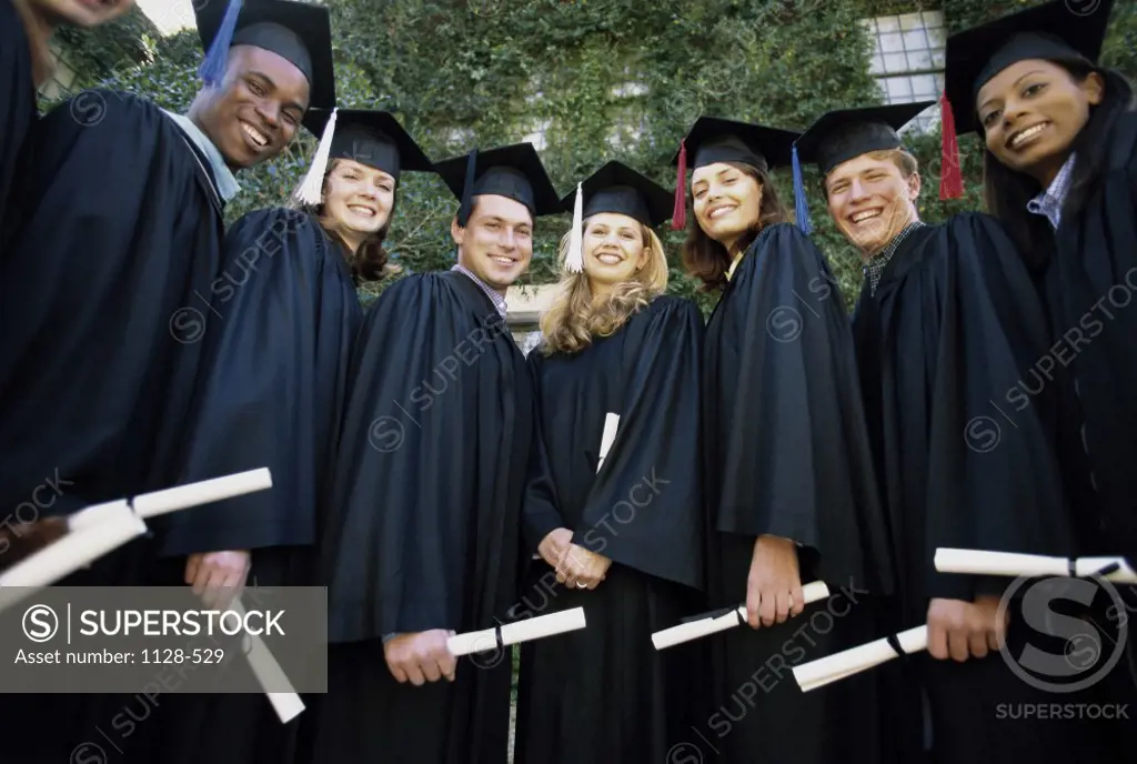 Portrait of a group of young graduates smiling
