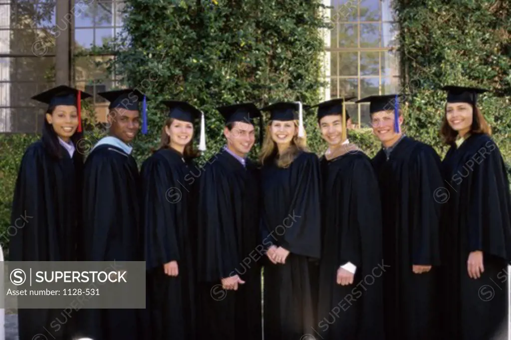 Portrait of a group of young graduates standing in a row