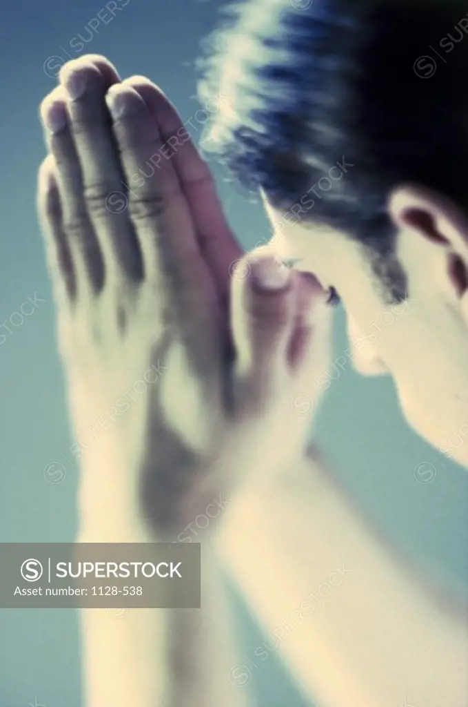 Side profile of a young man praying