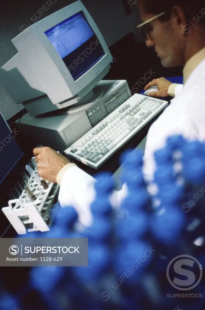 Male scientist operating a computer in a laboratory