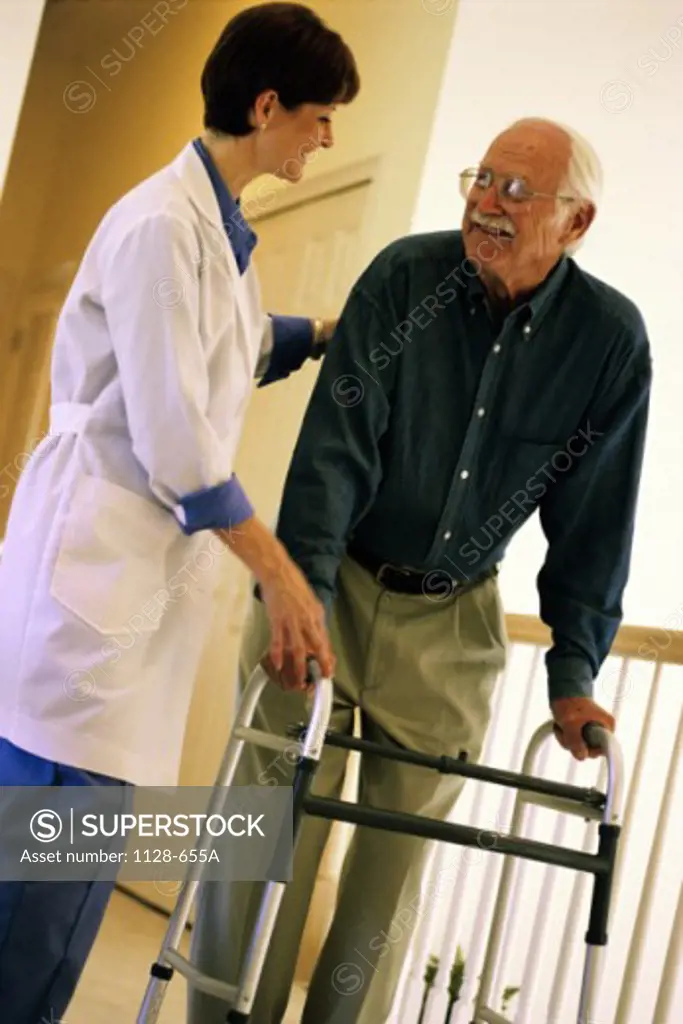 Female nurse helping a male patient with a walker