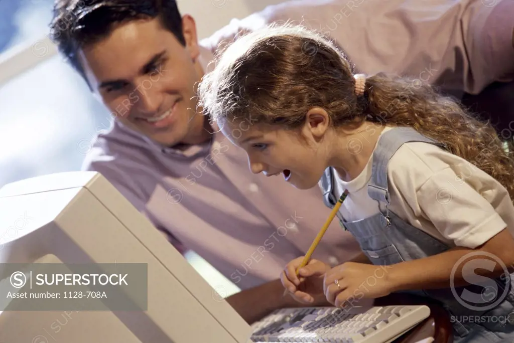 Father and his daughter using a computer