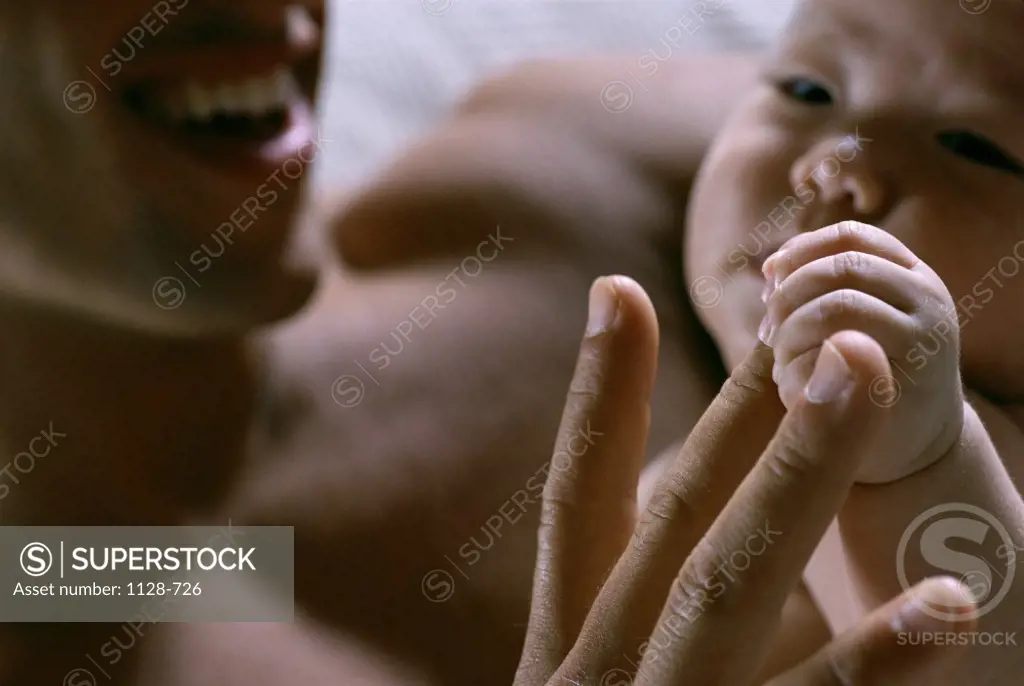 Close-up of a father playing with his baby boy