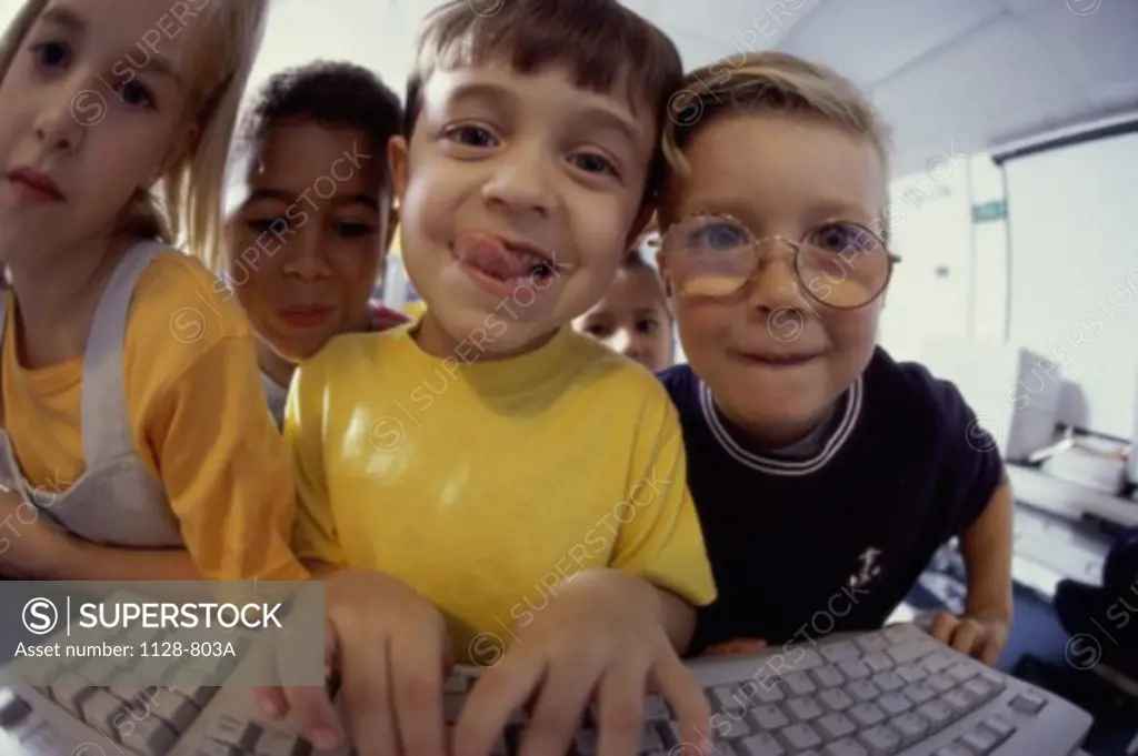 Portrait of a group of children using a computer