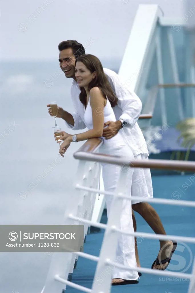 Side profile of a young couple standing on a cruise ship