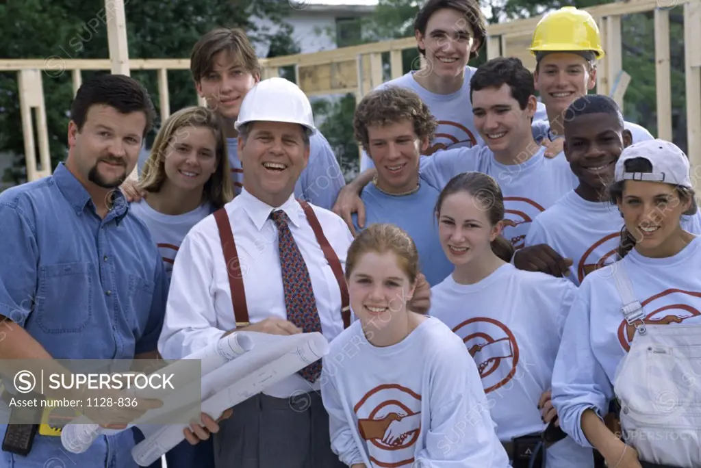 Portrait of a group of young people with an architect at a construction site