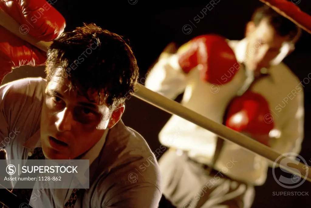 Two businessmen in a boxing ring