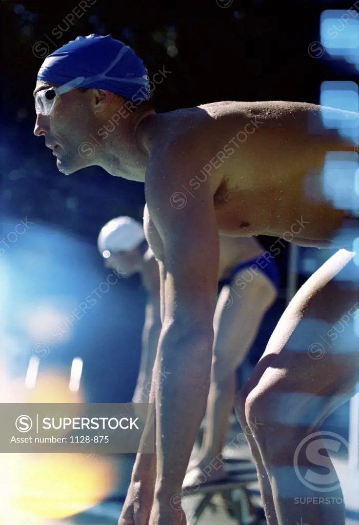 Side profile of two swimmers in the starting position