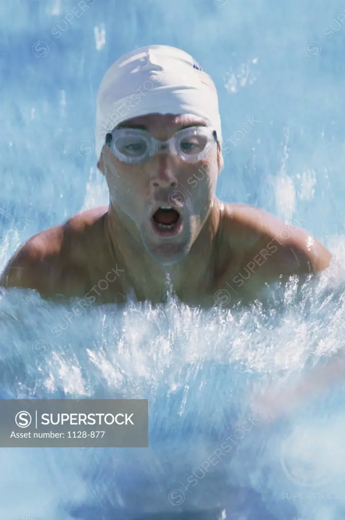 Close-up of a young man swimming the breaststroke