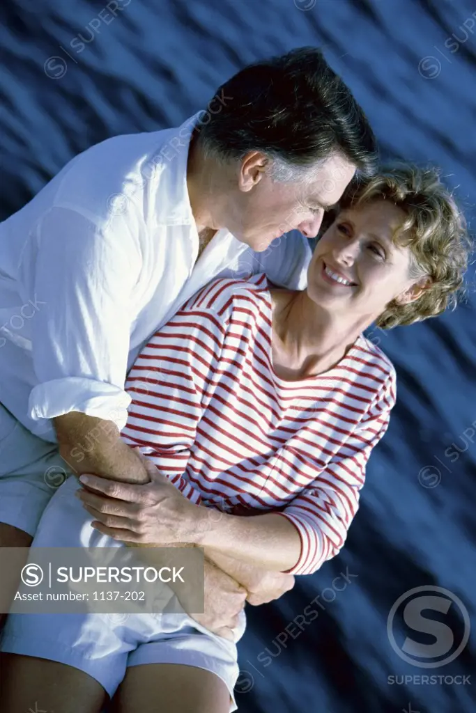 Mid adult couple holding each other