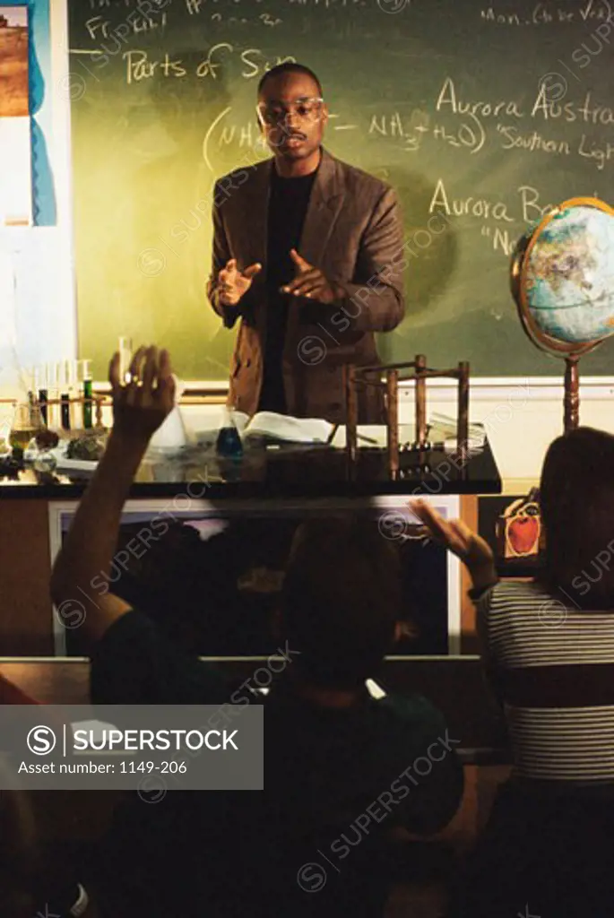 Teacher explaining students in a classroom