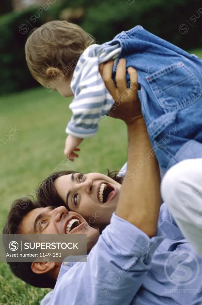 Parents on a lawn with their son