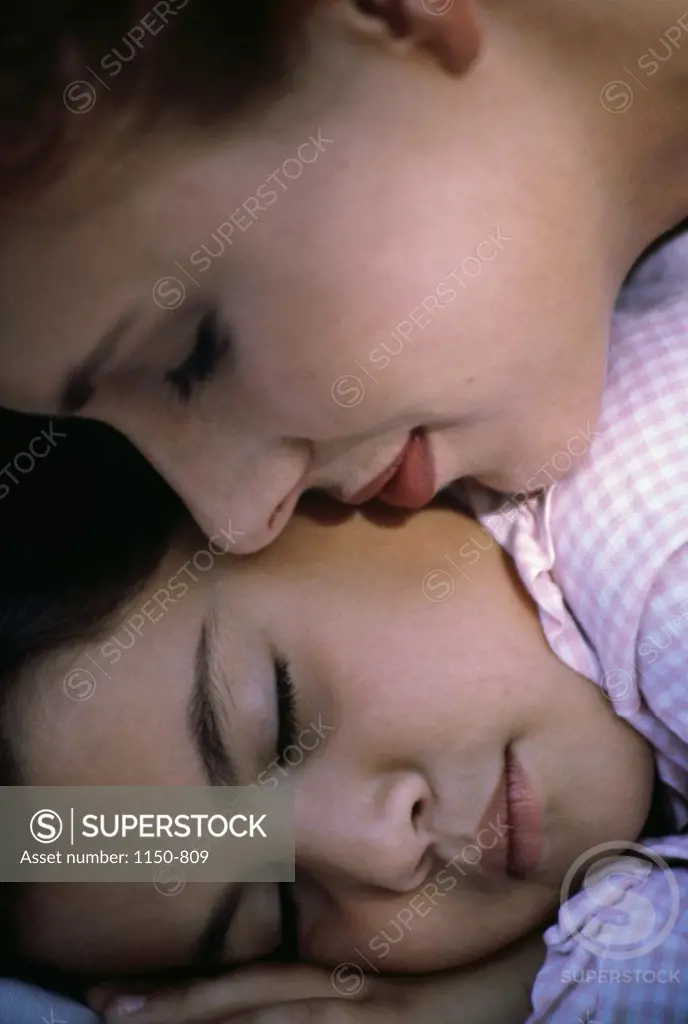 Close-up of a child sleeping with her mother