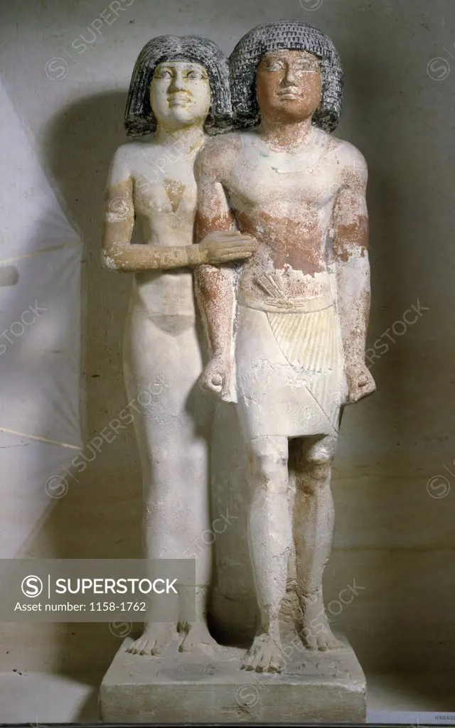 Statue of men and woman standing together, France, Paris, Musee du Louvre