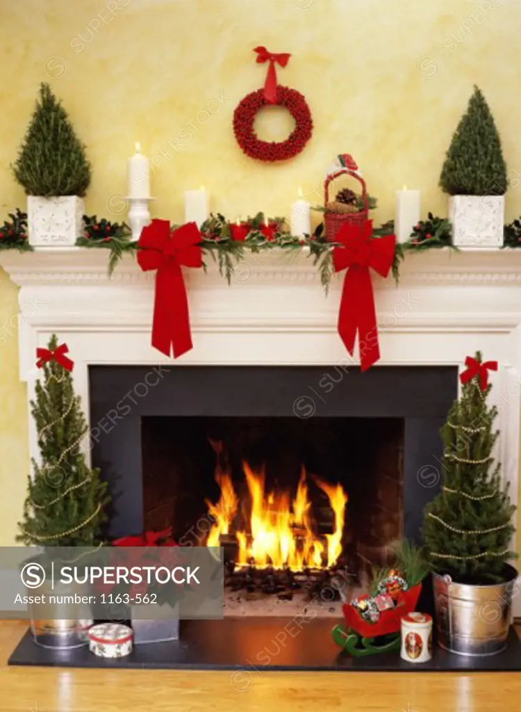 Christmas trees near a fireplace