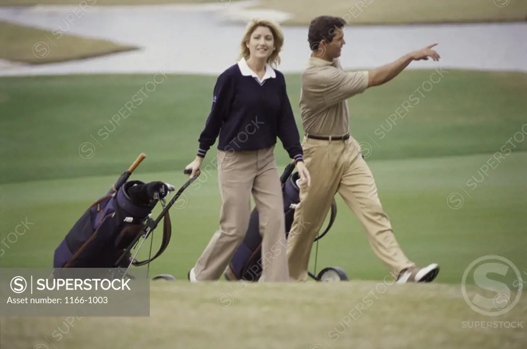 Young couple walking on a golf course