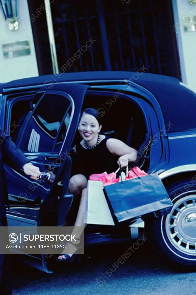 Young woman stepping out of a car