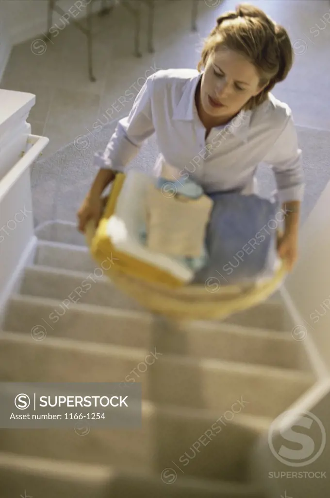 High angle view of a young woman climbing up stairs