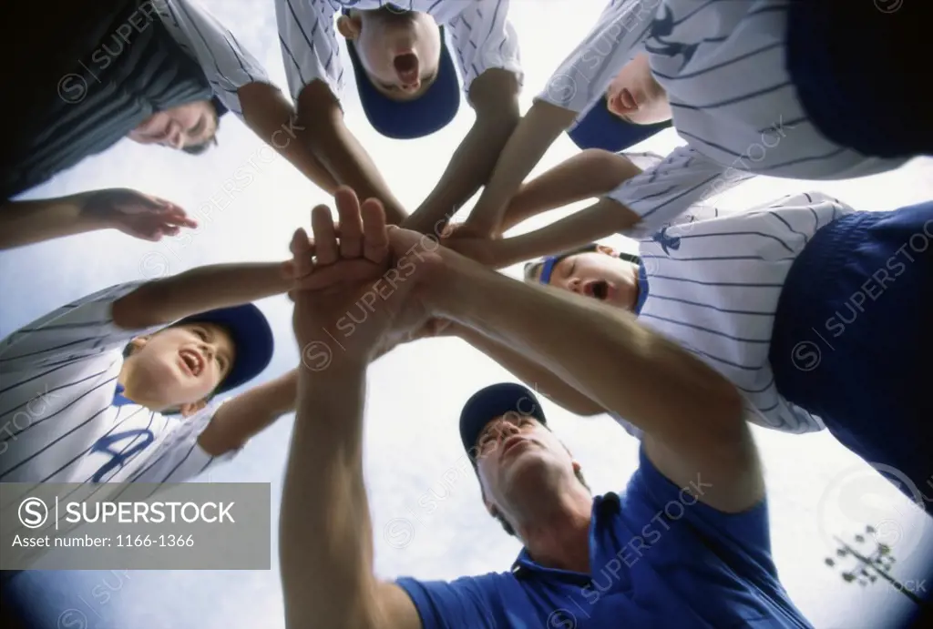 Low angle view of children of a baseball team in a huddle