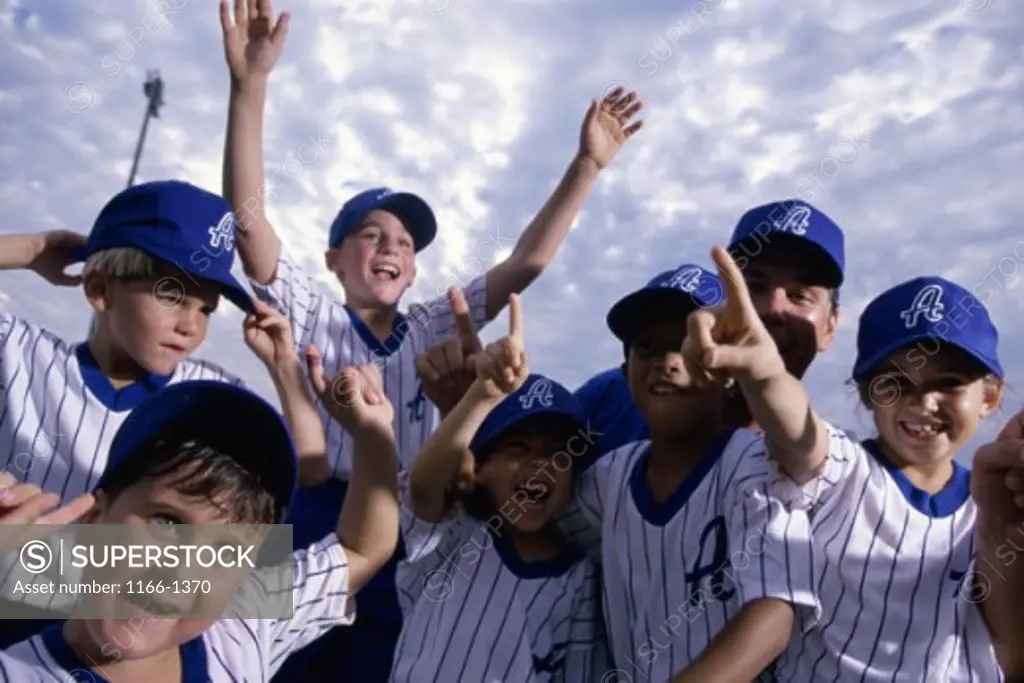 Group of boys on a baseball team celebrating together