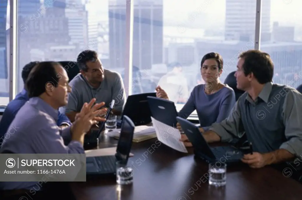 Group of business executives talking in an office