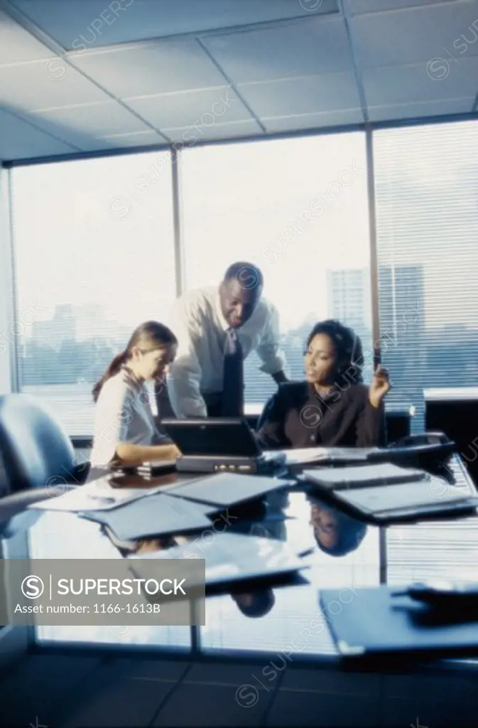 Three business executives working in an office