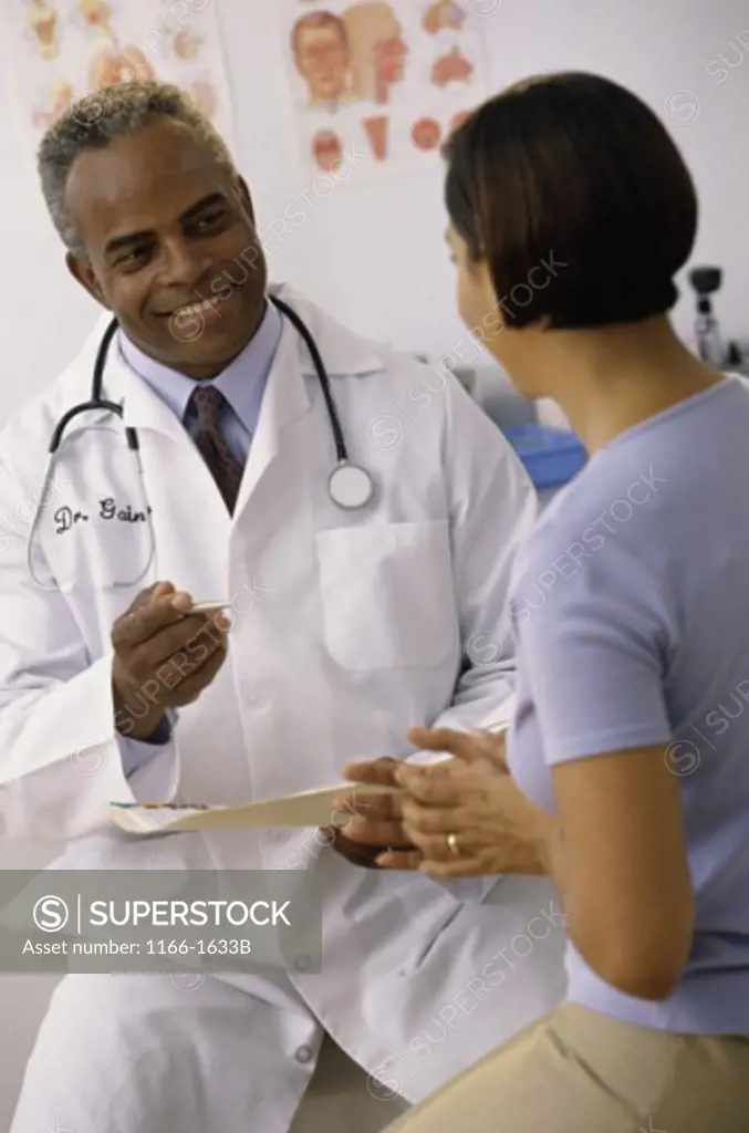 Male doctor talking to a female patient