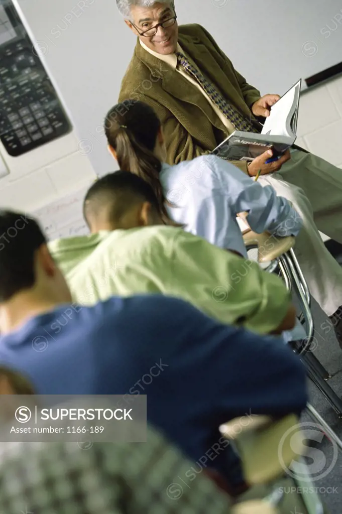 Group of teenagers taking an exam in a classroom