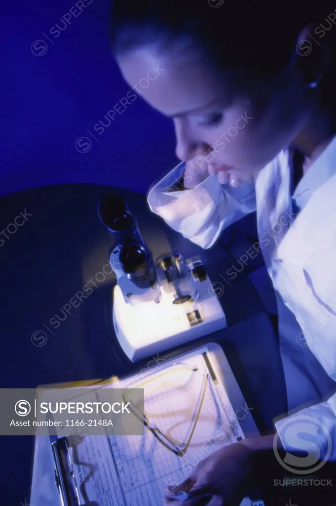 Female scientist looking at a clipboard in a laboratory