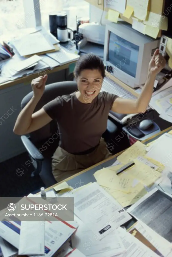 Portrait of a businesswoman with her arms raised