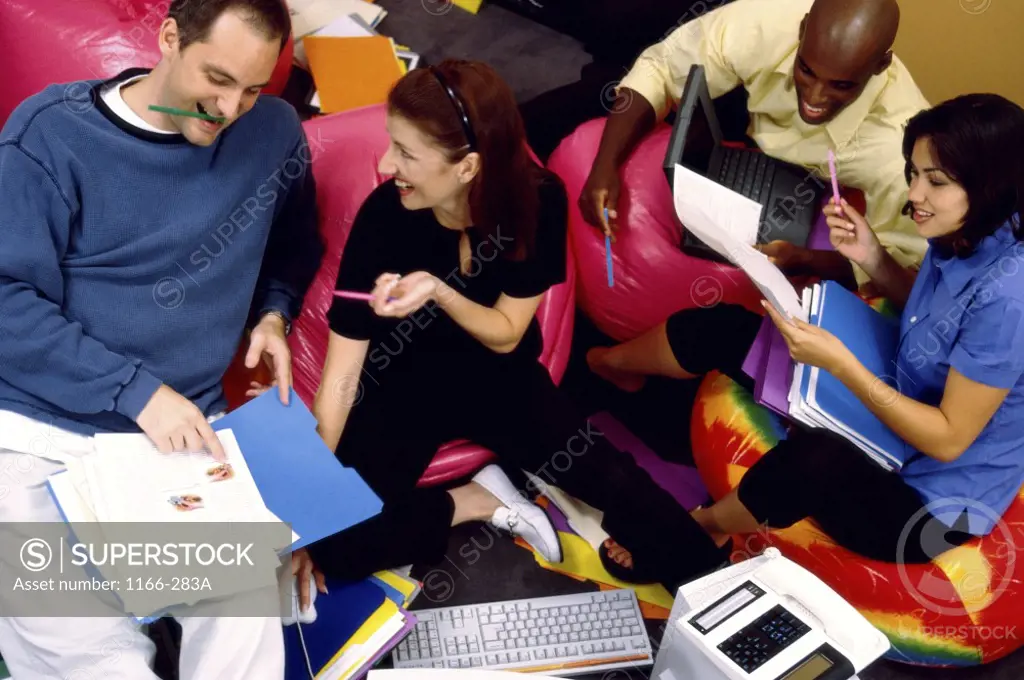 Two businessmen and two businesswomen working in an office