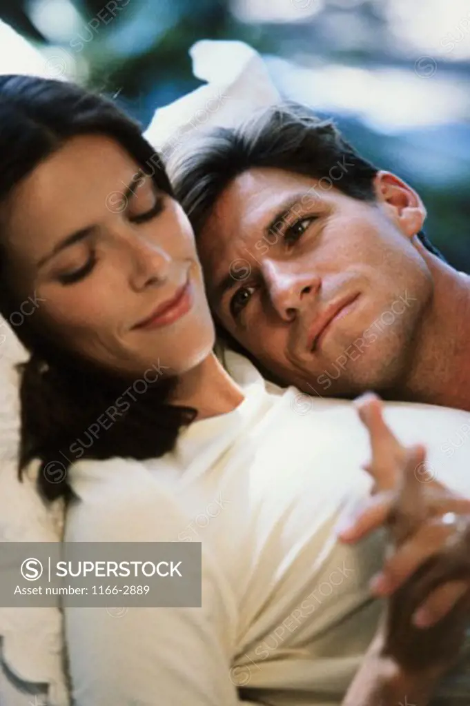 Close-up of a young couple lying on the bed