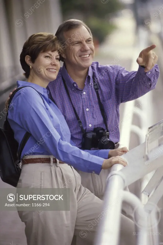 Mature couple on a cruise ship with a camera