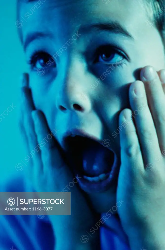 Close-up of a boy screaming