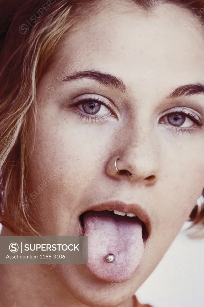 Portrait of a girl with her tongue pierced