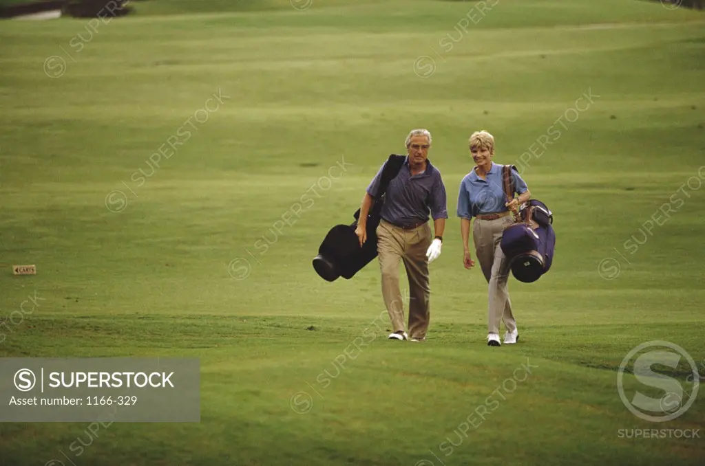 Senior couple walking on a golf course