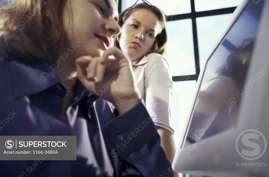 Two businesswomen using a computer