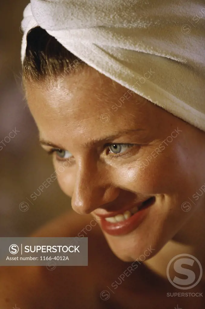 Close-up of a young woman with a towel wrapped around her head
