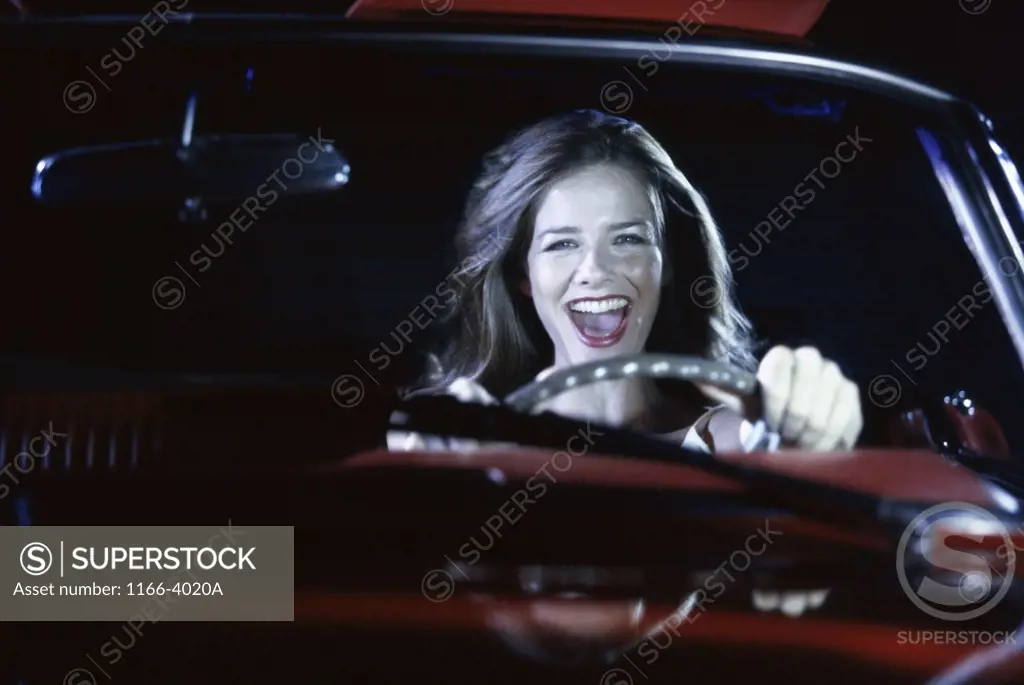 Portrait of a young woman driving a car