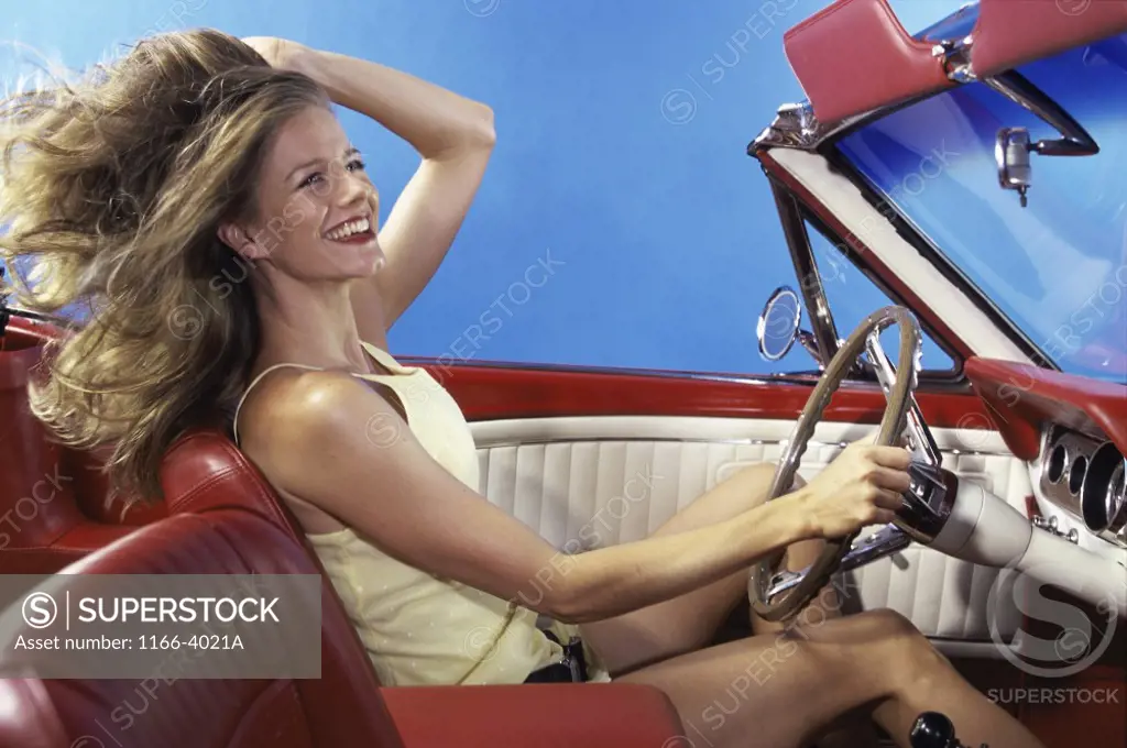 Side profile of a young woman driving a car