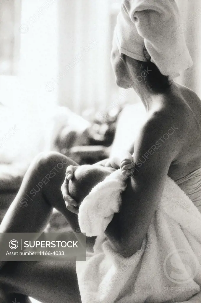 Side profile of a mother breastfeeding her baby girl