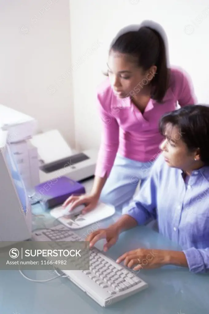 Mother and her daughter working on a computer
